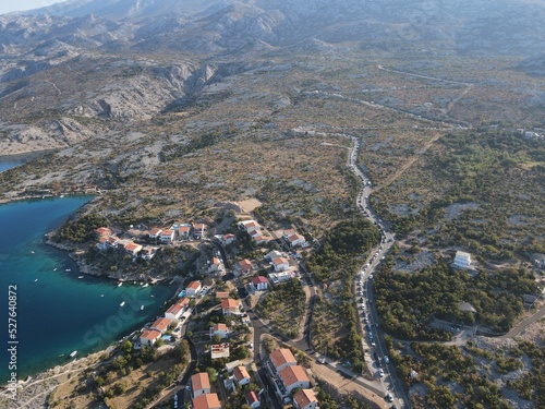 Aerial view of Prizna, Trajekt Prizna-Zigljen to reach the island of Pag. Drone view of queue to catch ferry for Pag. Small town with turquoise water on the hill of Croatia, in Dalmatia. © AerialDronePics