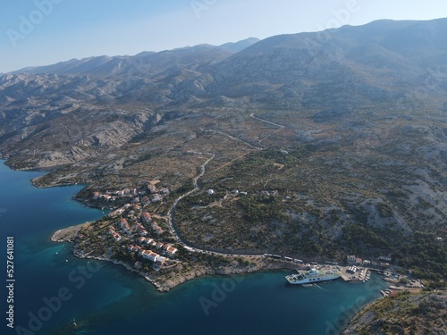 Aerial view of Prizna, Trajekt Prizna-Zigljen to reach the island of Pag. Drone view of queue to catch ferry for Pag. Small town with turquoise water on the hill of Croatia, in Dalmatia. photo