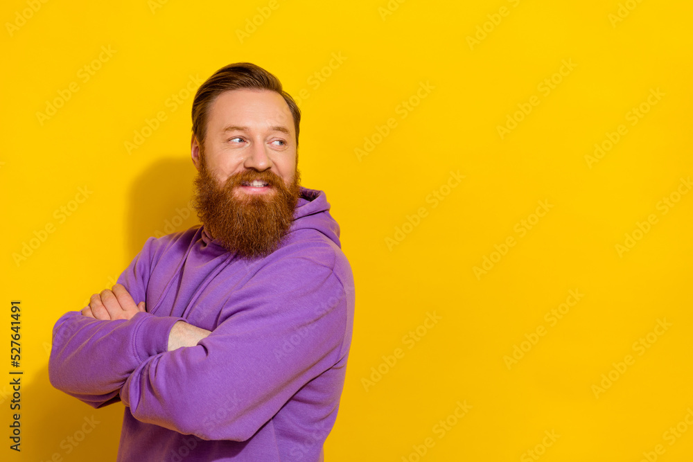 Profile portrait of cheerful man crossed arms toothy smile look empty space isolated on yellow color background Profile portrait of cheerful man crossed arms toothy smile look empty space isolated on yellow color background