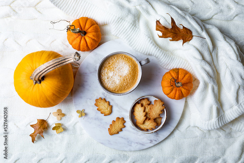 Fall cozy holiday background with cup of coffee, cookies, pumpkins and wool knitted plaid. Warm autumn mood flat lay.  Breakfast in bed