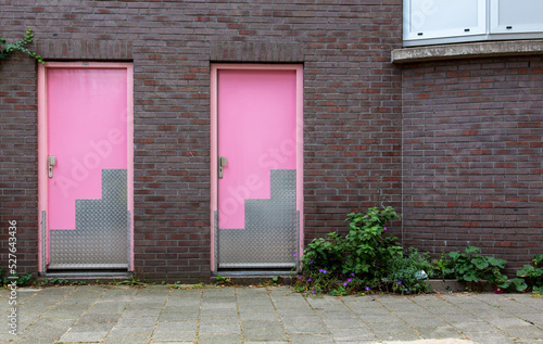 Amsterdam house front with pink doors.