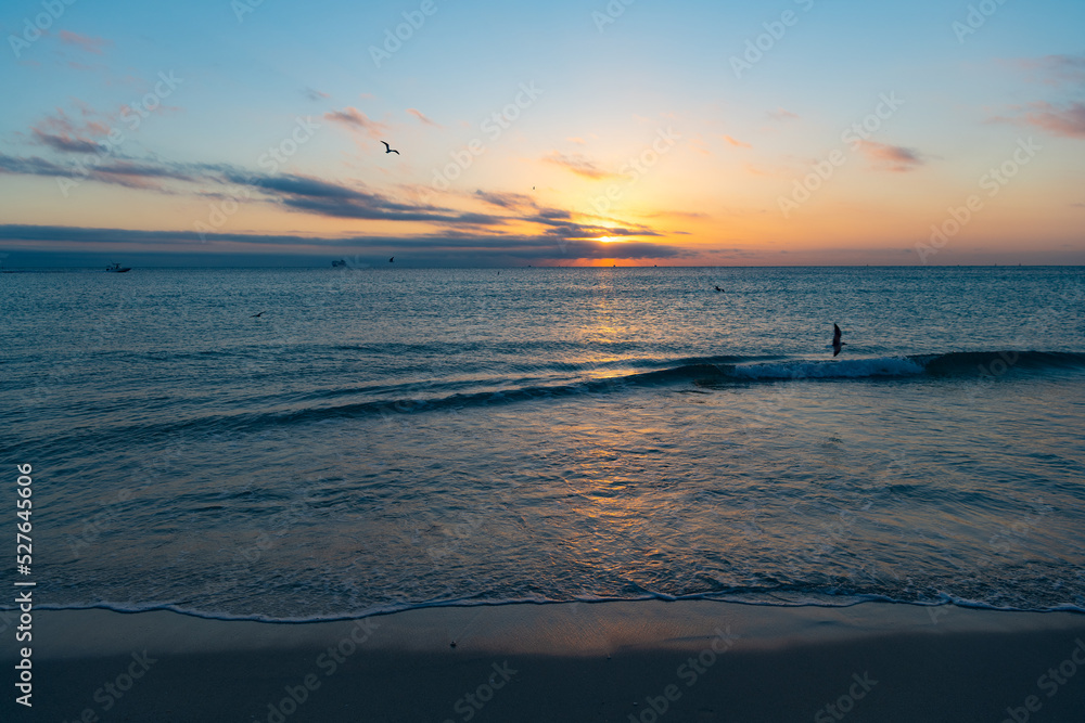 romantic sunset with sea water on the summer beach