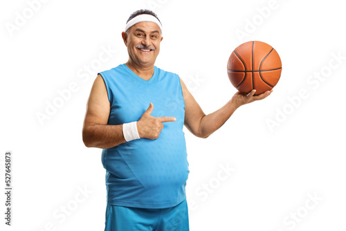 Happy mature man holding a basketball and pointing