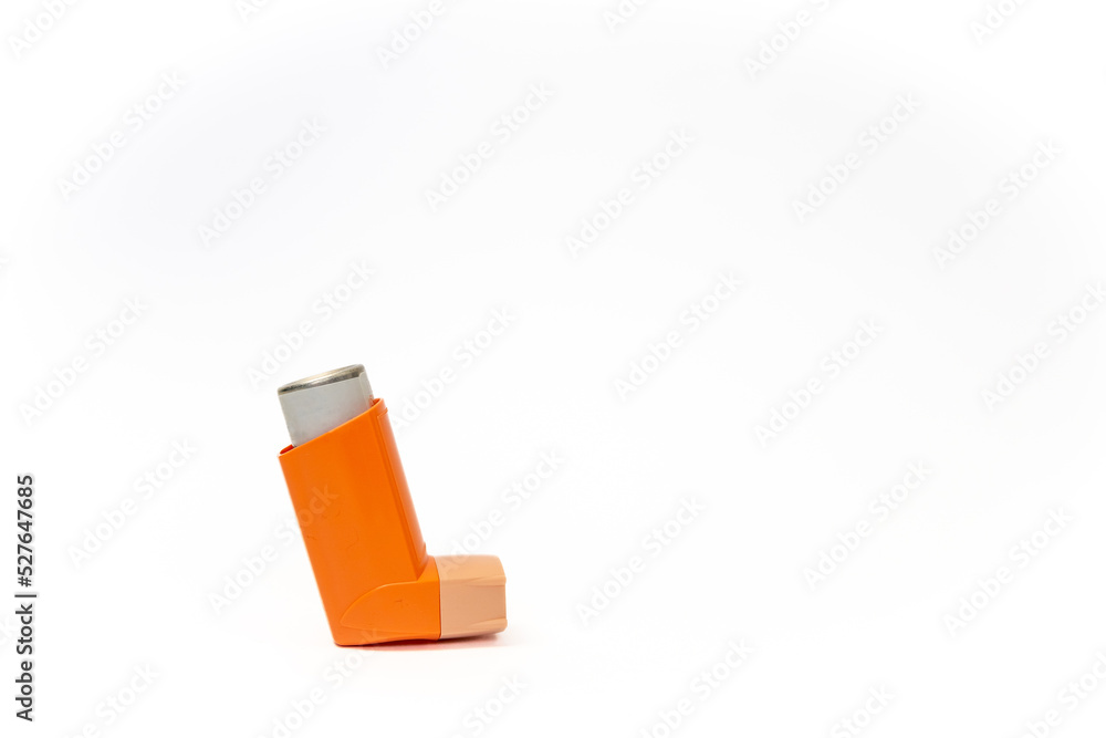 Side view of an orange aerosol spray canister inside leaving copy space. Basic and necessary tool for patients with asthma and similar diseases. Respiratory health concept. Side view of an orange aerosol spray canister inside leaving copy space. Basic and necessary tool for patients with asthma and similar diseases. Respiratory health concept.