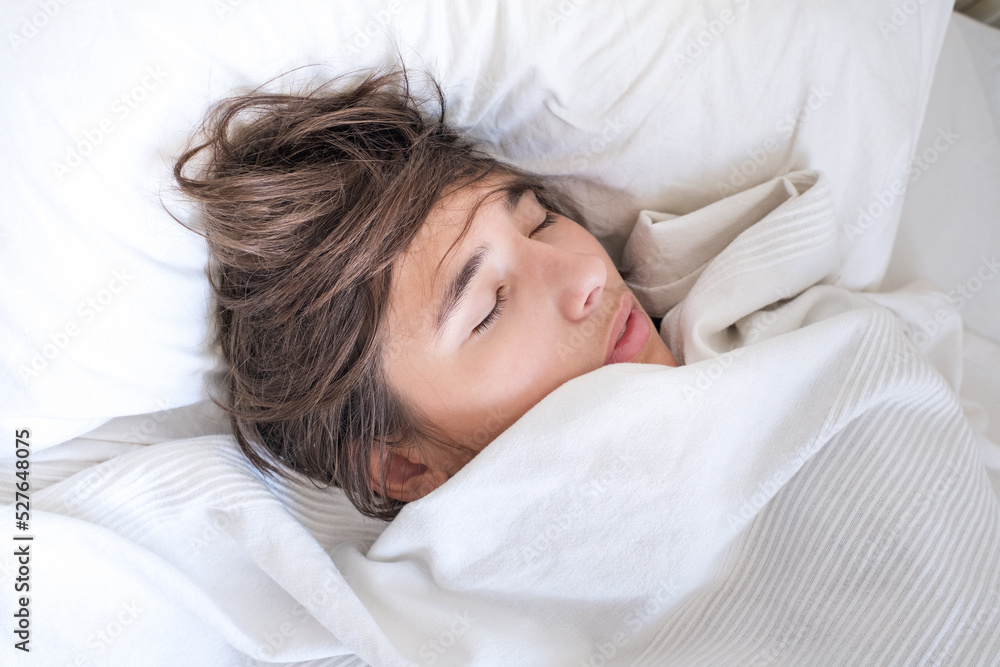 Closeup of a teen boy sleeping on a bed Closeup of a teen boy sleeping on a bed