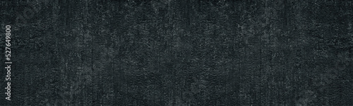 Black textured concrete wall. Dark cement surface texture. Grunge background