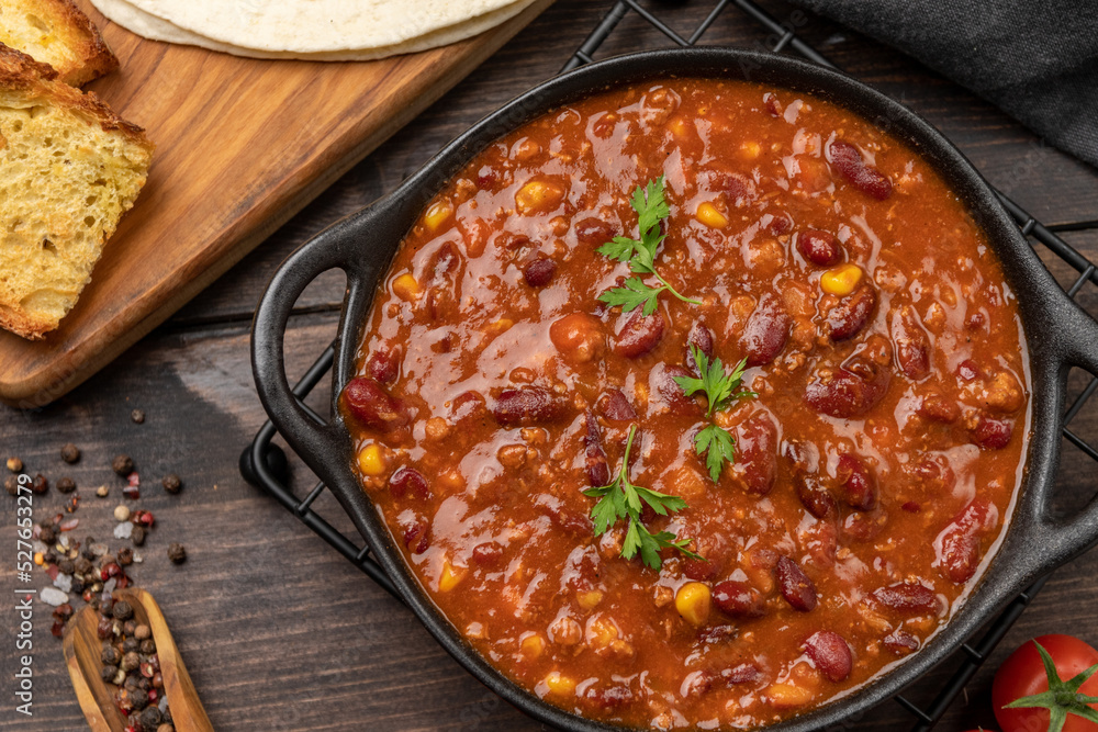 Bean and corn soup or ragout, red bean stew on a wood background Bean and corn soup or ragout, red bean stew on a wood background