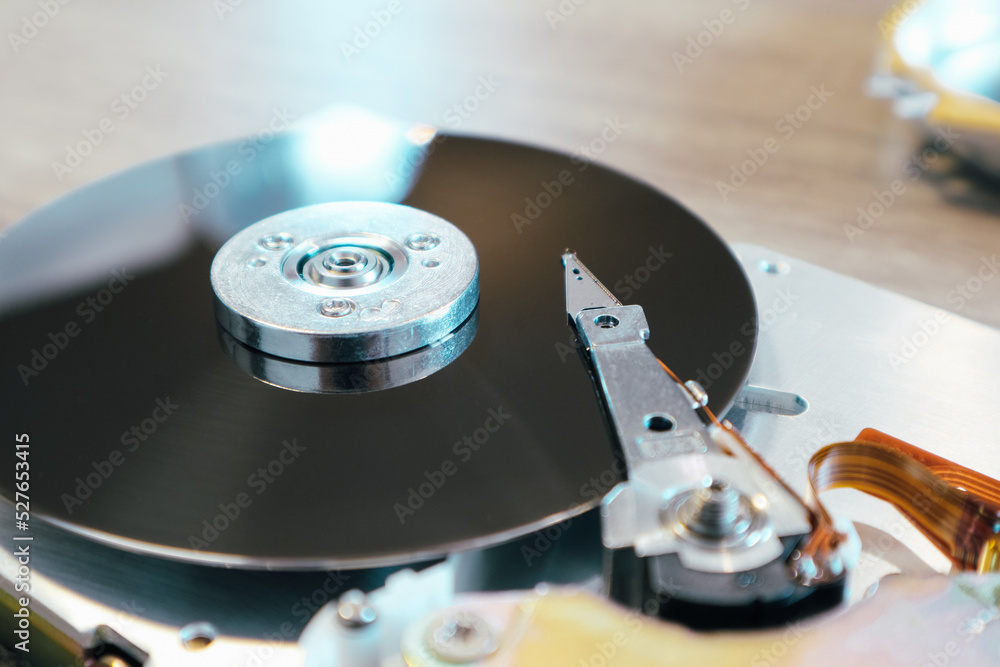 Disassembled computer hard drive. Data hard drive backup disc hdd disk restoration. Disassembled hard drive from the computer, hdd with mirror effect. Disassembled computer hard drive. Data hard drive backup disc hdd disk restoration. Disassembled hard drive from the computer, hdd with mirror effect.