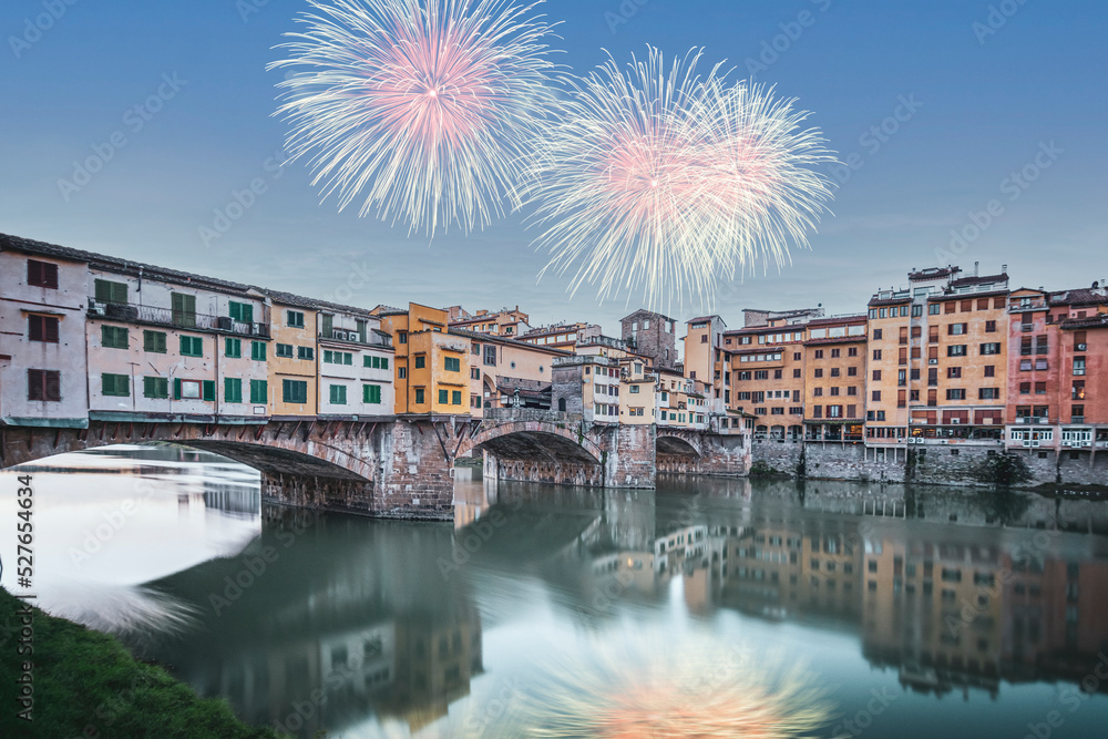 Florence city view fireworks on sky famous architecture of touristic destination Ponte Vecchio bridge
