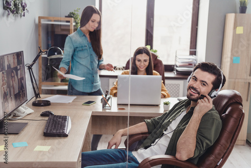 Portrait of three employees manager sitting chair speak communicate video call indoors photo