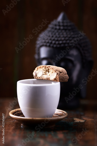 Cantuccini (Italian cookie) and a Cup of coffee on dark wooden background. Copy space