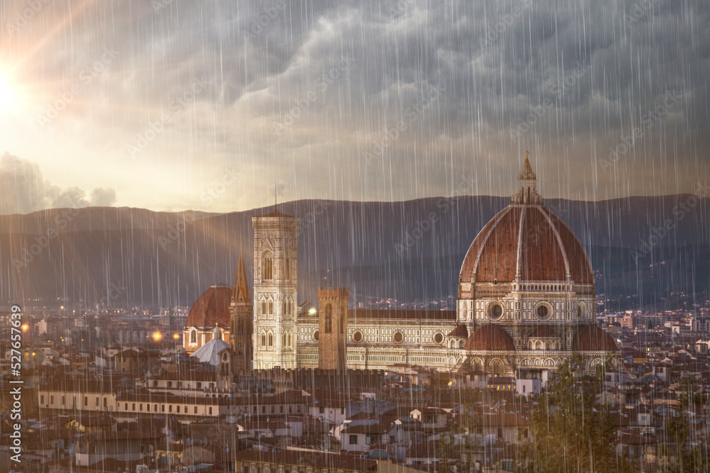 Fototapeta premium Florence city view rain clouds and sun beams on sky famous architecture of touristic destination 