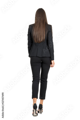 Elegant woman in business black suit walking away. Back view isolated on transparent background.	
