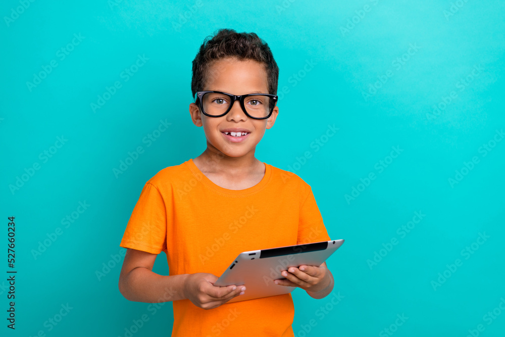 Photo of pretty cute small man wear yellow t-shirt eyeglasses chatting facebook telegram modern device isolated turquoise color background - obrazy, fototapety, plakaty 