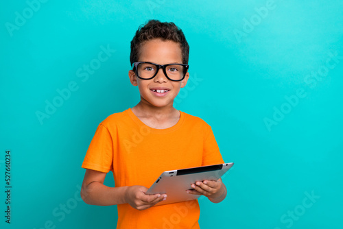 Photo of pretty cute small man wear yellow t-shirt eyeglasses chatting facebook telegram modern device isolated turquoise color background