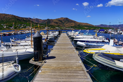 Small boats docked in the marina of a picturesque village on the Costa Brava, Port de la Selva, Catalonia. photo