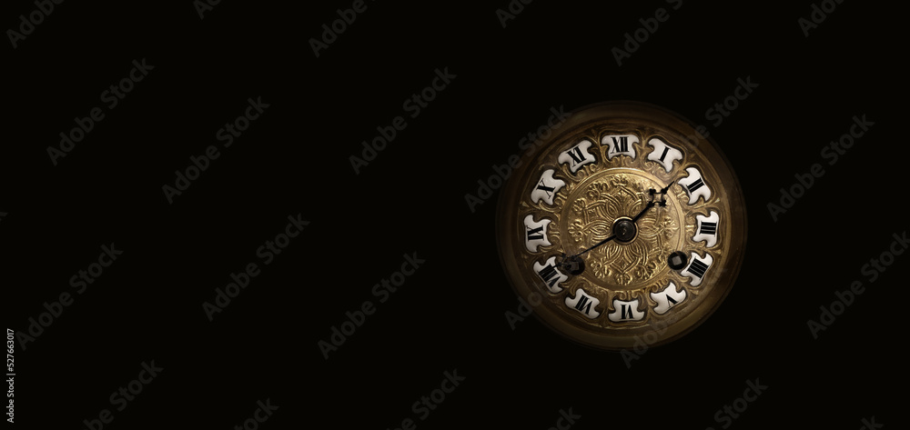An old antique clock with roman numerals on the dial, isolated on black An old antique clock with roman numerals on the dial, isolated on black