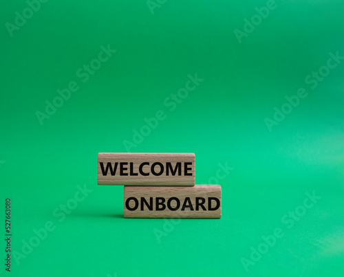 Welcome onboard symbol. Concept words Welcome onboard on wooden blocks. Beautiful green background. Business and Welcome onboard concept. Copy space.