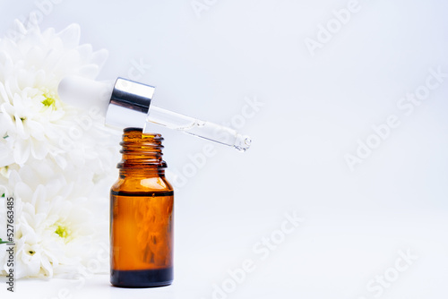 Essential oil and white chrysanthemum flowers, copy space