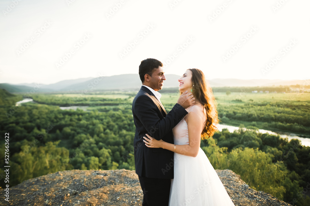 Gorgeous happy couple standing close to each other and looking in eyes