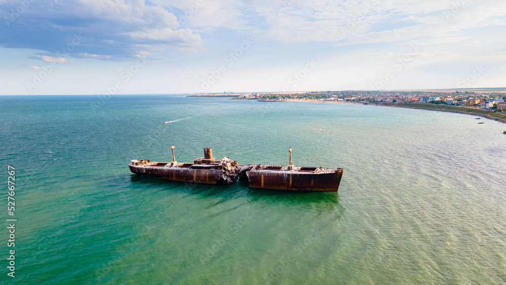 Drone photography of a rusty shipwreck at the Black Sea located next to Costinesti beach, in Romania. Aerial photography shot from a drone at a higher altitude. Drone photography of a rusty shipwreck at the Black Sea located next to Costinesti beach, in Romania. Aerial photography shot from a drone at a higher altitude.