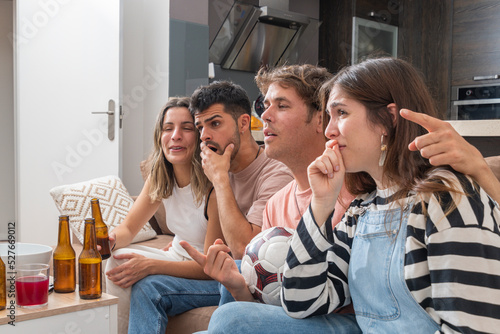 Two couples watching a soccer game