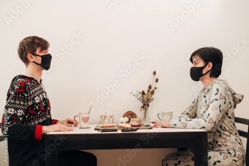 Girl and Guy Drinking Tea at Home in Masks