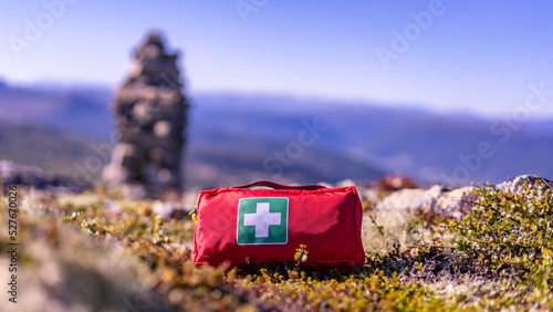 First aid kit in red case is ready for big hiking trip in mountains