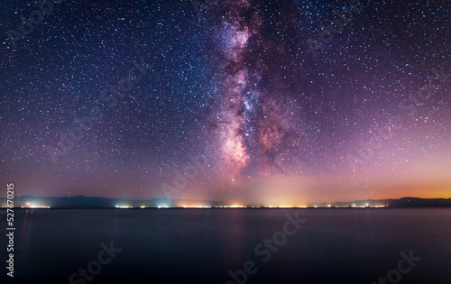 Night landscape. Beautiful lake in the night under starry sky with bright miky way galaxy.