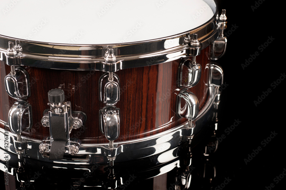 part of a snare drum on a black background with reflection, for advertising and inscriptions part of a snare drum on a black background with reflection, for advertising and inscriptions