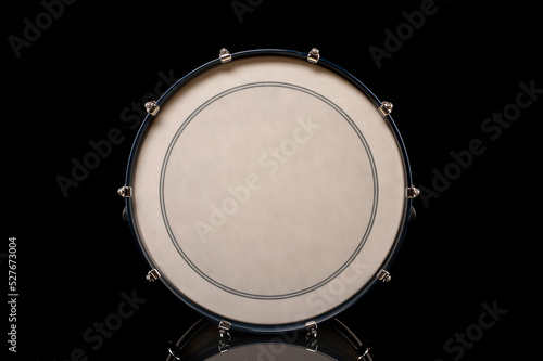 drum head of bass drum on a black background with reflection, for advertising and inscription photo