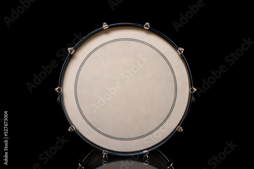 drum head of bass drum on a black background with reflection, for advertising and inscription