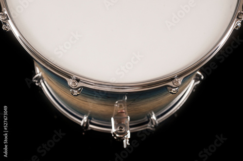 part of beautiful tom drum on a black background with reflection, for advertising and inscription