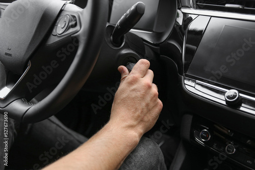 MAN HOLDING IGNITION KEY IN CAR © RaspberryStudio