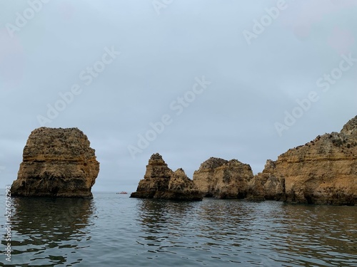 Boat with tourists visiting the caves near the beach ( praia da Marinha ), Algarve