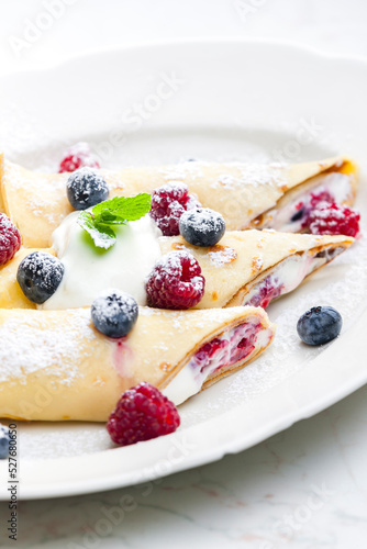 pankaces filled with blueberries, raspberries and cream