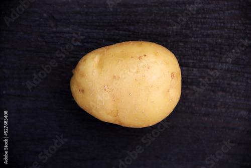 Fresh potatoes on a wooden background