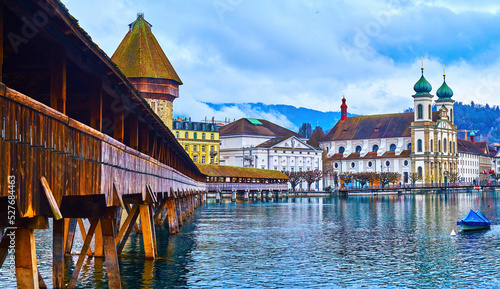 Kapellbrucke, the wooden medieval bridge across Reuss river, and the stone Water tower (Wasserturm) in Lucerne, Switzerland