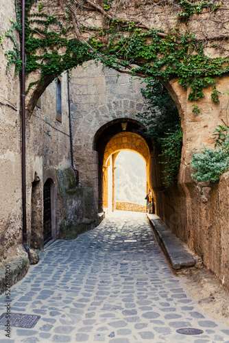 Ancient alley in the old town with buildings and arches. way to future. place for text  background for quotes  light at the end of the tunnel