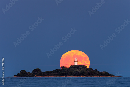 Moonrise over lighthouse