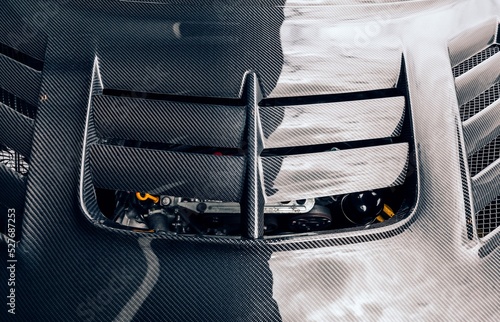 Фототапет Looking down on a carbon fiber aftermarket hood on a car