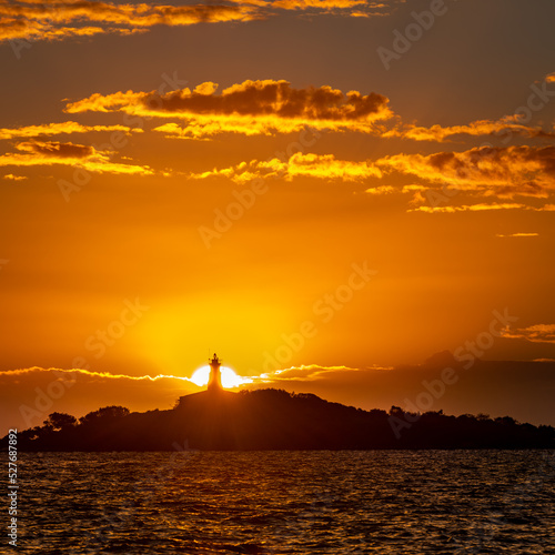 Sunrise over lighthouse on a island