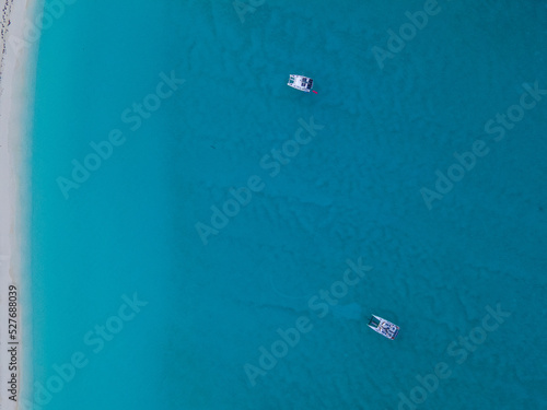 Aerial drone shot of a sailboat anchored in the Bahamas