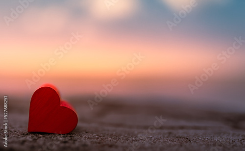 Heart isolated on colorful sunset nature view. Love and romance concept. 