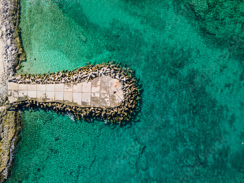 Aerial view of waves crashing onto dyke  © ishootforthegram