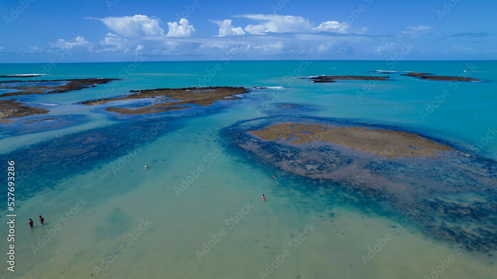 Obraz premium Aerial view of Praia do Espelho, Porto Seguro, Bahia, Brazil. Natural pools in the sea, cliffs and greenish water