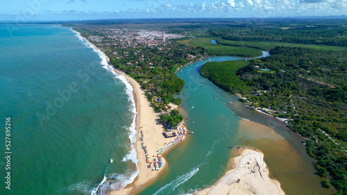 Aerial view of Caraiva beach, Porto Seguro, Bahia, Brazil. Colorful beach tents, sea and river