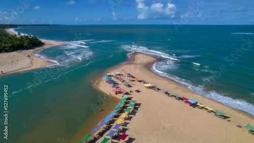 Fototapeta Naklejka Na Ścianę i Meble -  Aerial view of Caraiva beach, Porto Seguro, Bahia, Brazil. Colorful beach tents, sea and river
