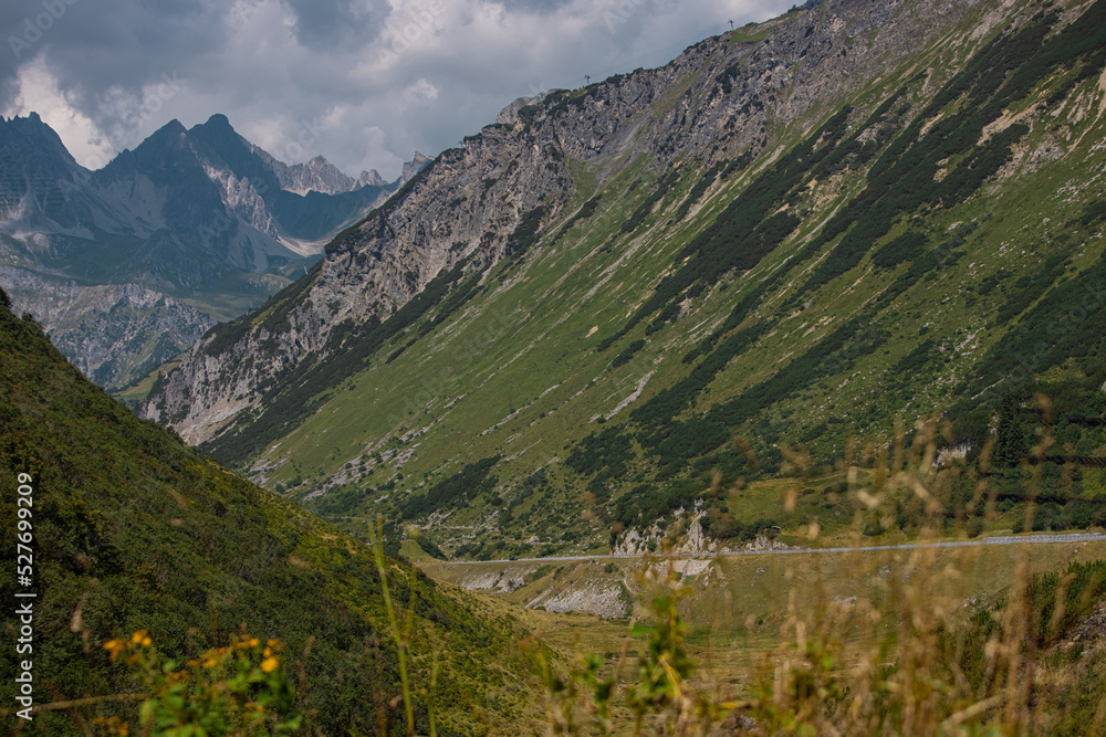 Road leading up to the arlberg pass or mountain road in northern austria on a beautiful summer day. Road leading up to the arlberg pass or mountain road in northern austria on a beautiful summer day.