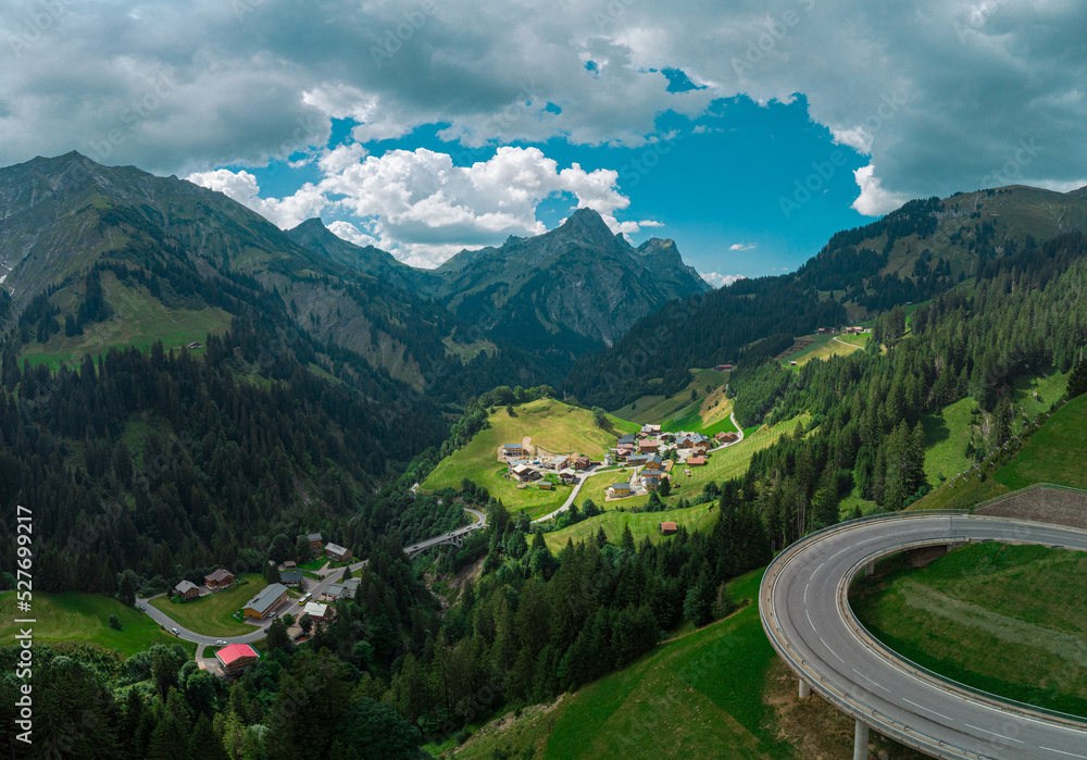 Beautiful austrian valley with village of Oberboden close to a nice road bridge with a hairpin turn on it with magnificent panorama of the mountains.